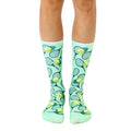 Pair of mint green crew socks with a fun tennis-themed design.  Features tennis rackets and yellow tennis balls on a pastel green background. [lf]