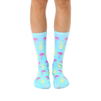 Pair of light blue crew socks with a fun, repeating pattern of pink palm trees and yellow pineapples.