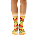A pair of crew socks with a realistic burger print.  The main colors are yellow, red, green, and brown. [lf]