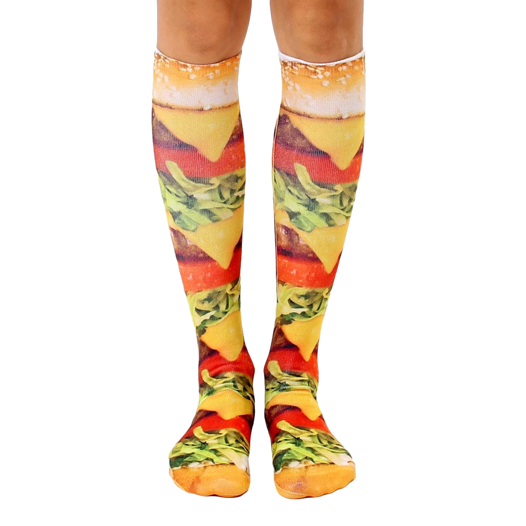 Pair of knee-high socks showcasing a realistic burger print.  Colors include yellows, browns, greens, and reds. [lf]