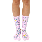 A pair of women's crew socks on a white background.  They're pink with a fun pattern of cartoon magic wands, crowns, and game controllers. [lf]
