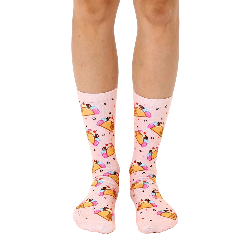 Pair of pink crew socks with a whimsical all-over print of ice cream tacos.  Features pink, brown, and pastel accents. [lf]