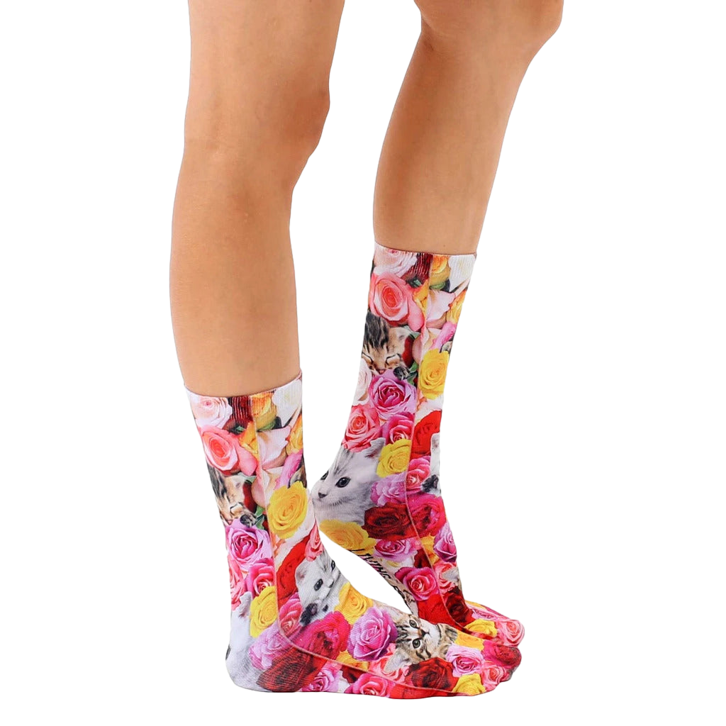 Lifestyle shot showcasing Kitty Garden crew socks on a model's legs, highlighting the sock's vibrant print and fit. [lf]