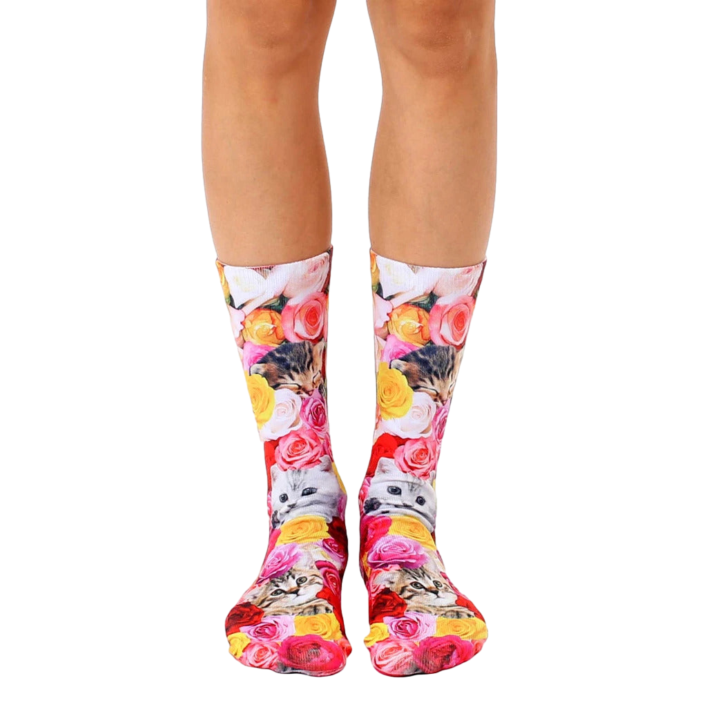 Crew socks with a whimsical print of kittens playfully hidden amongst pink, yellow, and red roses. [lf]