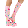 Lifestyle shot of model wearing pink llama socks; showcasing fit and style. [lf]