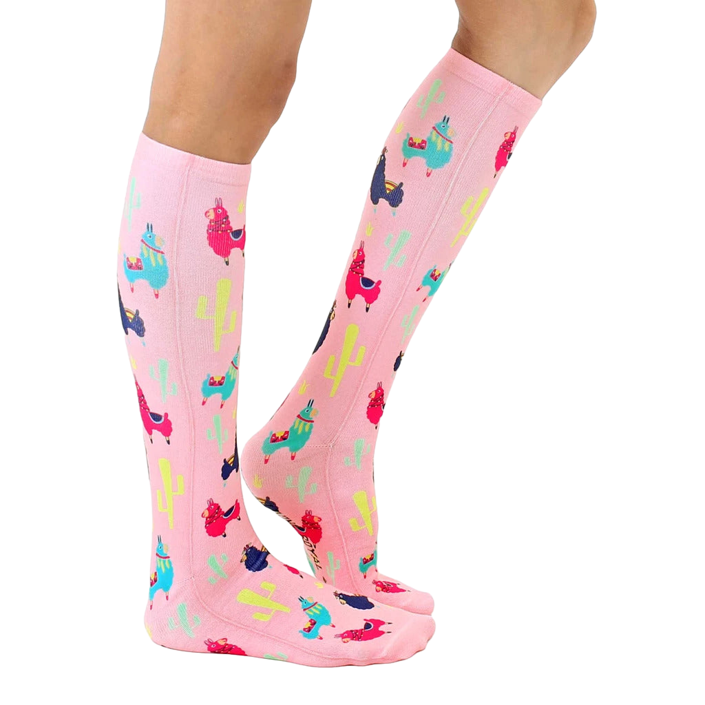 Lifestyle shot of model wearing pink llama socks; showcasing fit and style. [lf]