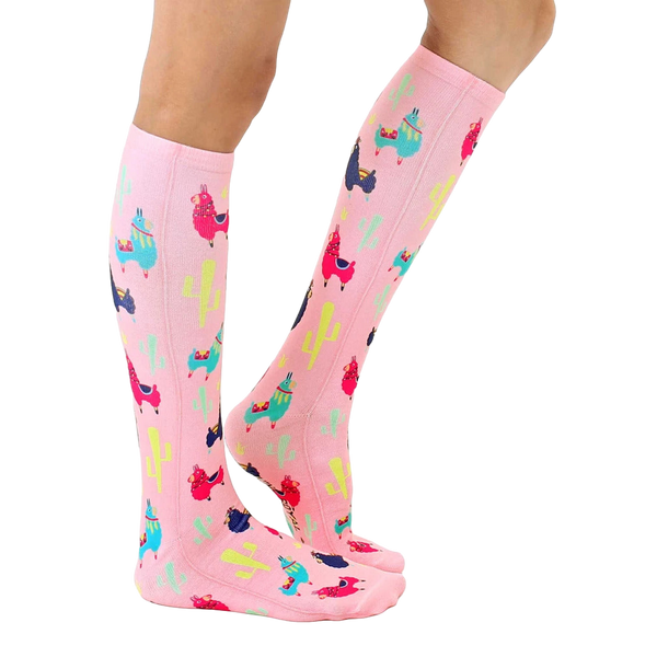 Lifestyle shot of model wearing pink llama socks; showcasing fit and style. [lf]