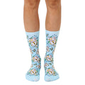 Pair of pastel blue crew socks with a repeating pattern of Maneki Neko (beckoning cat) illustrations and white flowers. [lf]