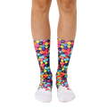 A pair of crew socks with a colorful fruity pebble design on a black background and white toe and heel. [lf]