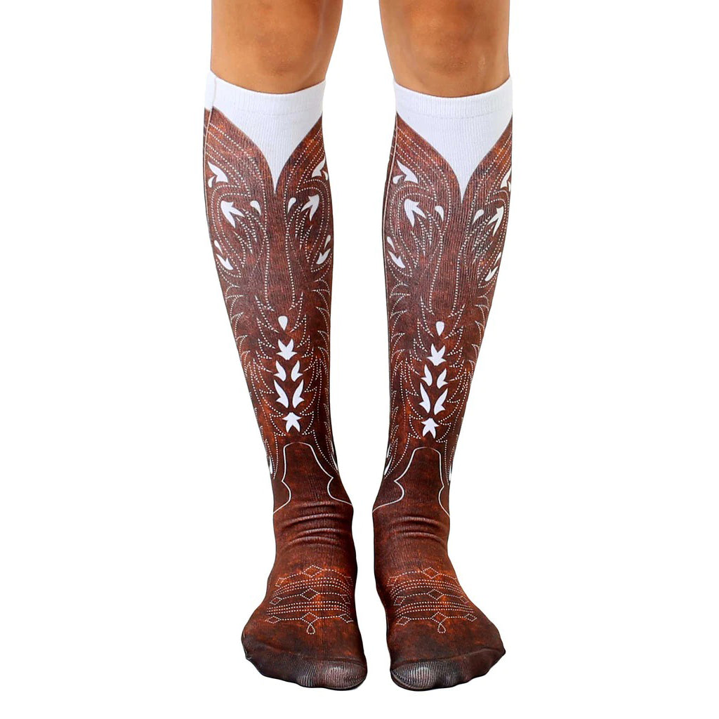 Pair of knee-high socks showcasing a brown cowboy boot design on a white background.  Detailed stitching and wear effects are visible. [lf]