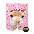 Ankle socks featuring a pink llama with a flower crown and jeweled necklace on a pink background with pink hearts. Glow-in-the-dark details. [lf]