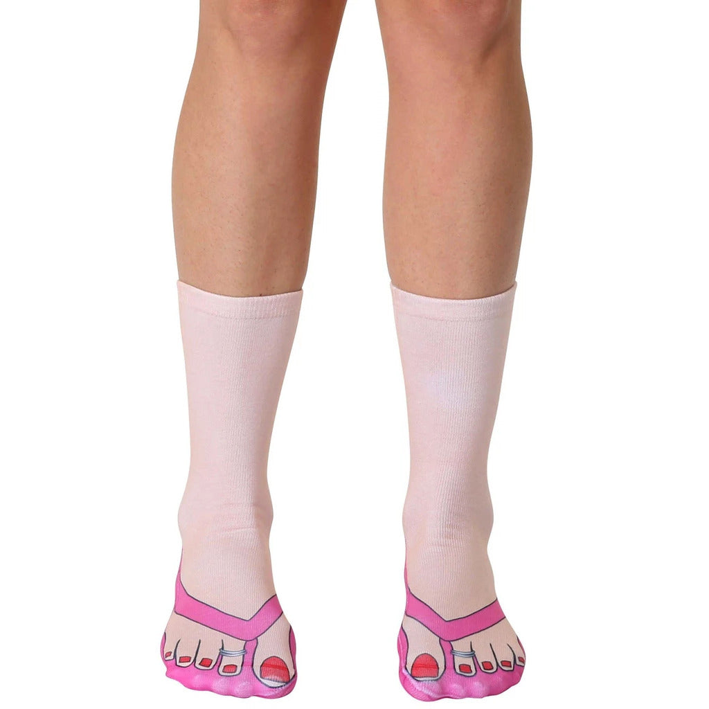 Pair of pink and white crew socks featuring a flip-flop design.  The toes of the socks are printed to look like feet in pink flip-flops with red nail polish. [lf]