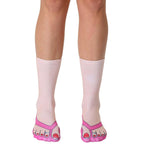 Pair of pink and white crew socks featuring a flip-flop design.  The toes of the socks are printed to look like feet in pink flip-flops with red nail polish. [lf]