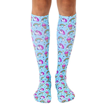 knee-high unicorn socks for women featuring unicorns, rainbows, ice cream cones, and clouds against a light blue background.  