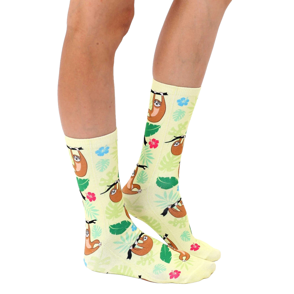 Lifestyle shot of a person's legs wearing the Tree Sloth socks, showing them styled with casual footwear. [lf]