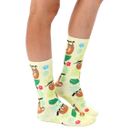 Lifestyle shot of a person's legs wearing the Tree Sloth socks, showing them styled with casual footwear. [lf]