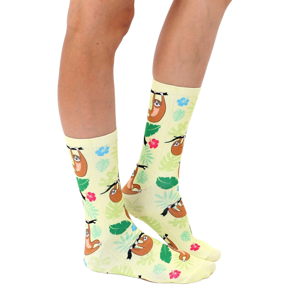 Lifestyle shot of a person's legs wearing the Tree Sloth socks, showing them styled with casual footwear. [lf]