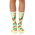 A pair of crew socks on a model's legs. Pale yellow background with cartoon sloths and tropical flowers. [lf]