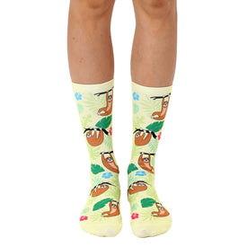 yellow crew socks for men & women with a pattern of cartoon sloths hanging from green trees and pink & blue flowers.  