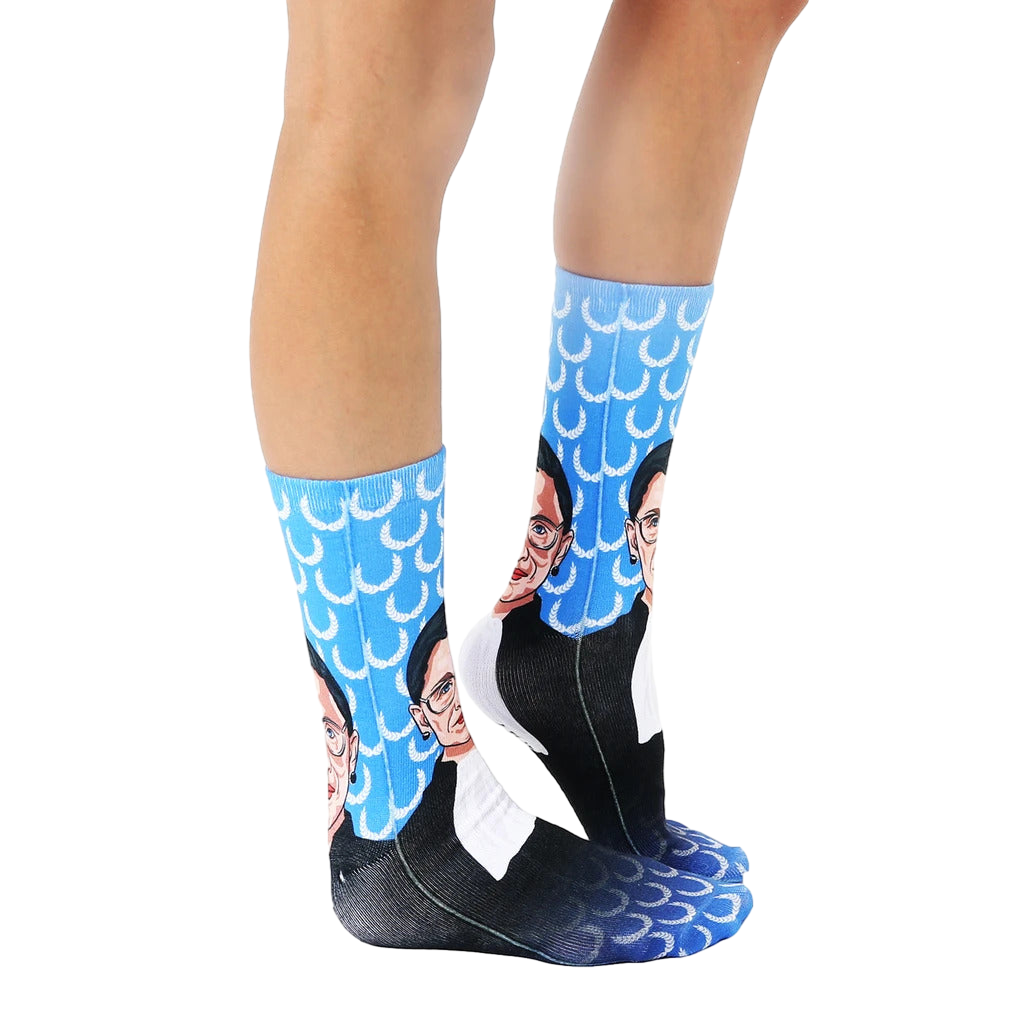 Lifestyle shot: Person wearing the Ruth Bader Ginsburg socks, showing them from the knees down. [lf]