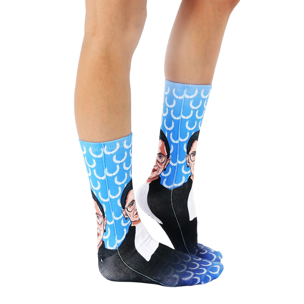 Lifestyle shot: Person wearing the Ruth Bader Ginsburg socks, showing them from the knees down. [lf]