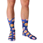 Lifestyle shot of a person wearing the Fast Food Galaxy socks. The socks' design is visible against the person's legs and skin tone. [lf]