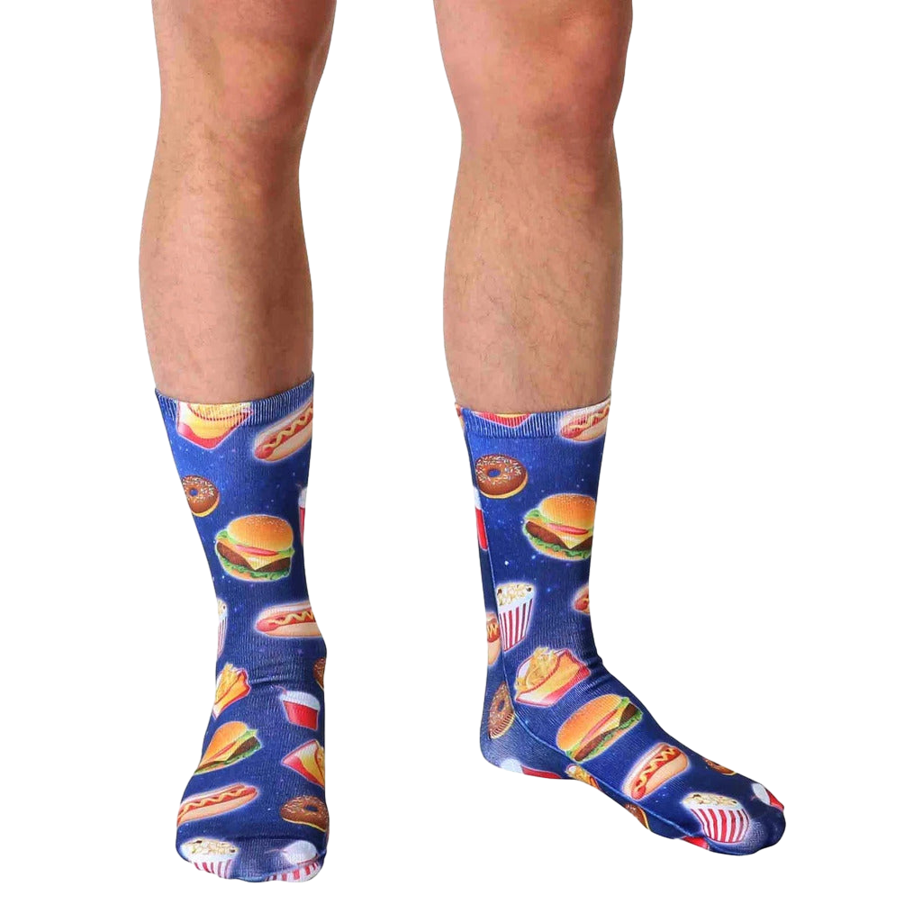 Lifestyle shot of a person wearing the Fast Food Galaxy socks. The socks' design is visible against the person's legs and skin tone. [lf]
