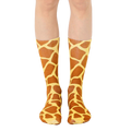 A pair of brown and tan crew socks with a giraffe print pattern.  The socks are shown on a person's legs against a white background. [lf]