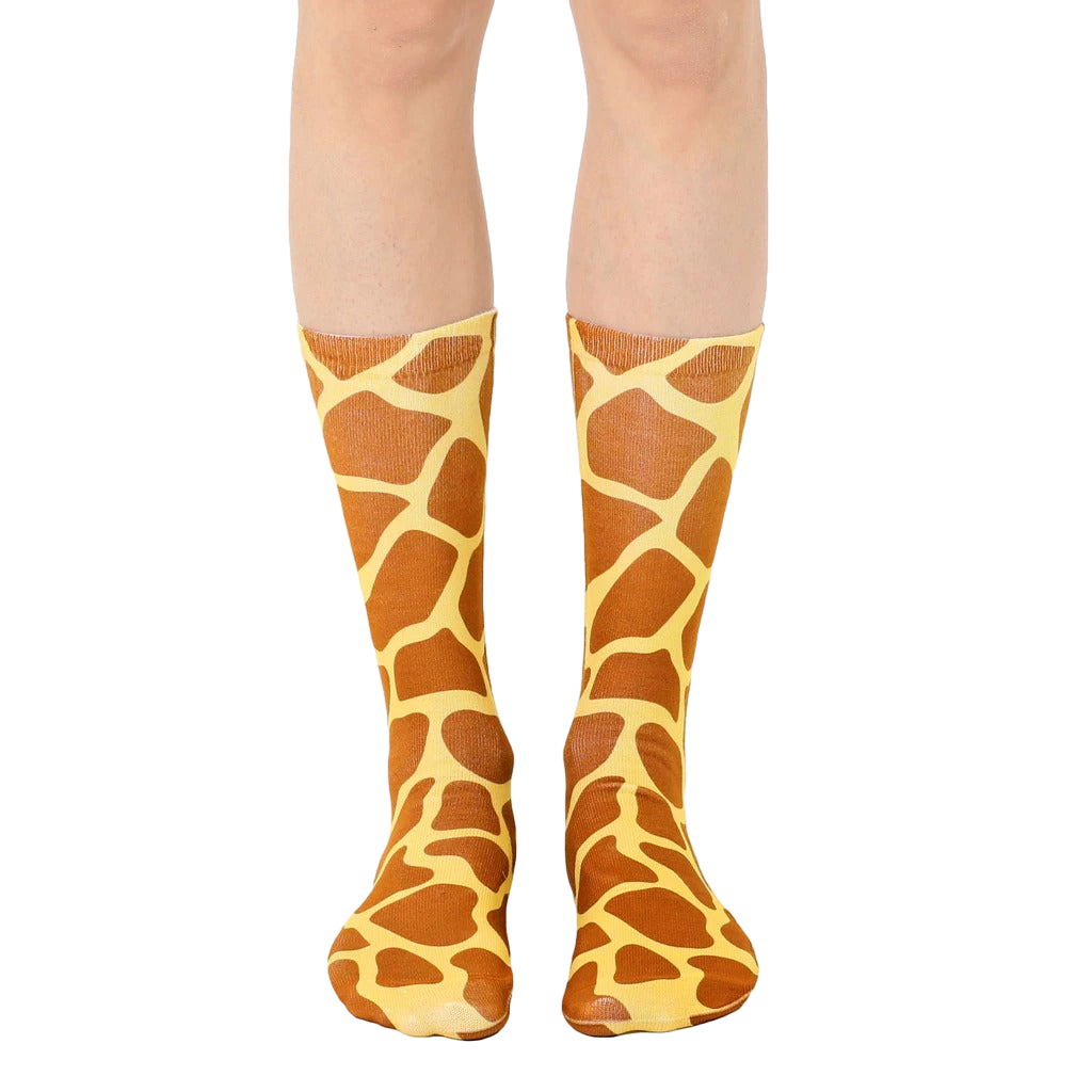 A pair of brown and tan crew socks with a giraffe print pattern.  The socks are shown on a person's legs against a white background. [lf]