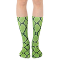 Pair of lime green and black snakeskin-print crew socks shown on a model's legs. [lf]