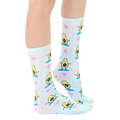 Lifestyle shot: Person's legs wearing the Avocado Yoga socks, showcasing the socks' fit and pattern. [lf]