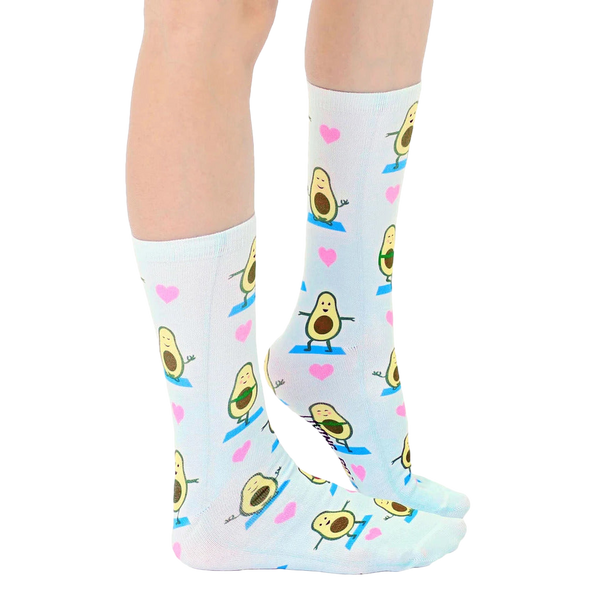 Lifestyle shot: Person's legs wearing the Avocado Yoga socks, showcasing the socks' fit and pattern. [lf]