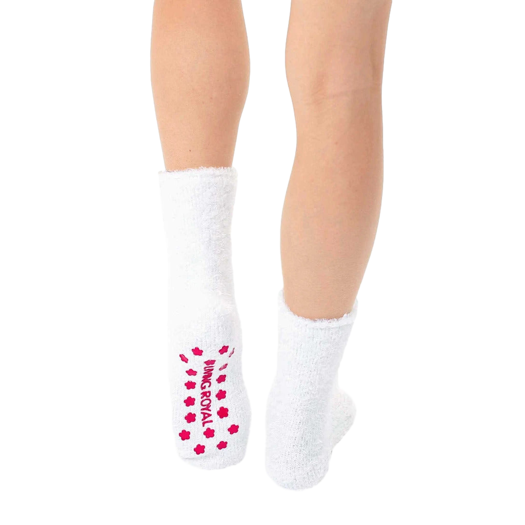 Back view of white fuzzy llama slipper socks, showcasing the pink non-slip grip. [lf]