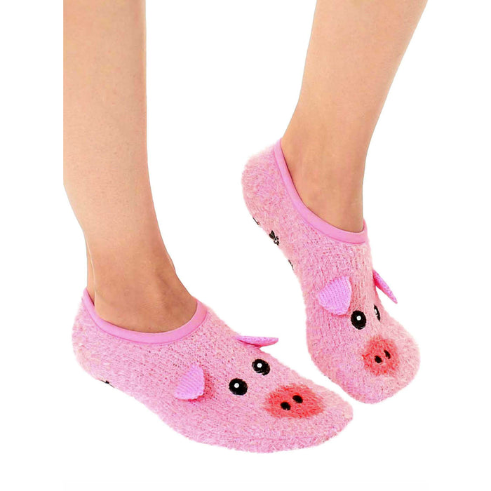A pair of pink fuzzy socks with pig faces on the toes.