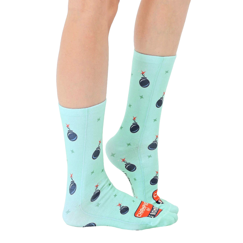 Lifestyle shot showing the 'Champion of F Bombs' socks on a person's legs, showcasing the fit and overall look. [lf]