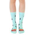 A pair of mint green crew socks with a repeating pattern of cartoon bombs and the text 'Champion of F Bombs'. [lf]
