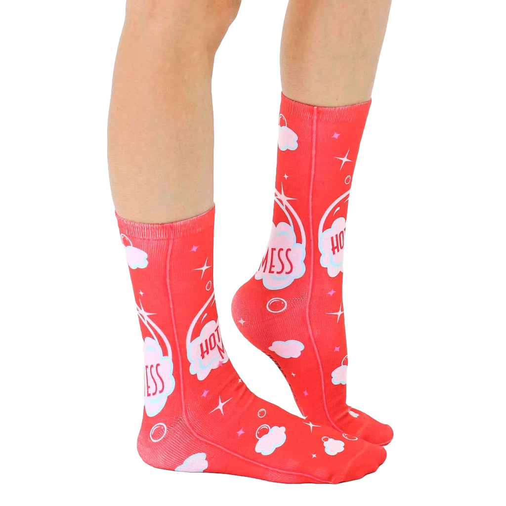 Lifestyle shot showing 'Hot Mess' socks on a person's legs, highlighting the sock's fit and design in a casual setting. [lf]