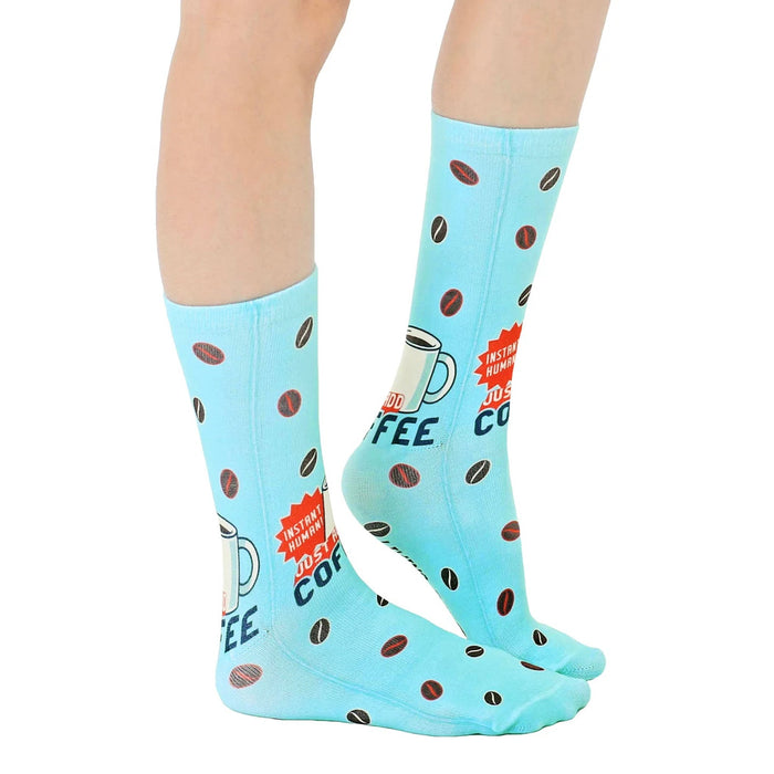 A pair of blue socks with a pattern of coffee beans and the words 