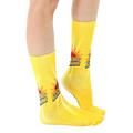 Lifestyle shot showing the socks on a person's legs;  bright yellow socks with sun graphic and phrase. [lf]