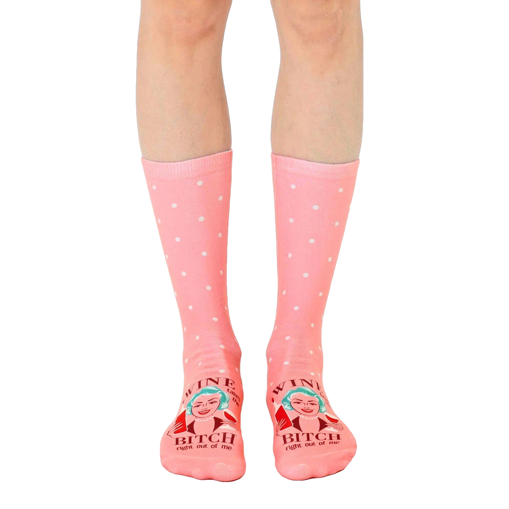Women's crew socks in pink with white polka dots and a retro illustration of a woman with wine, saying 'Wine Bitch'. [lf]
