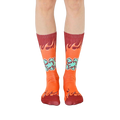 A pair of orange crew socks with maroon flames and 'Sorry I Farted' text in teal. Fun and comfortable!