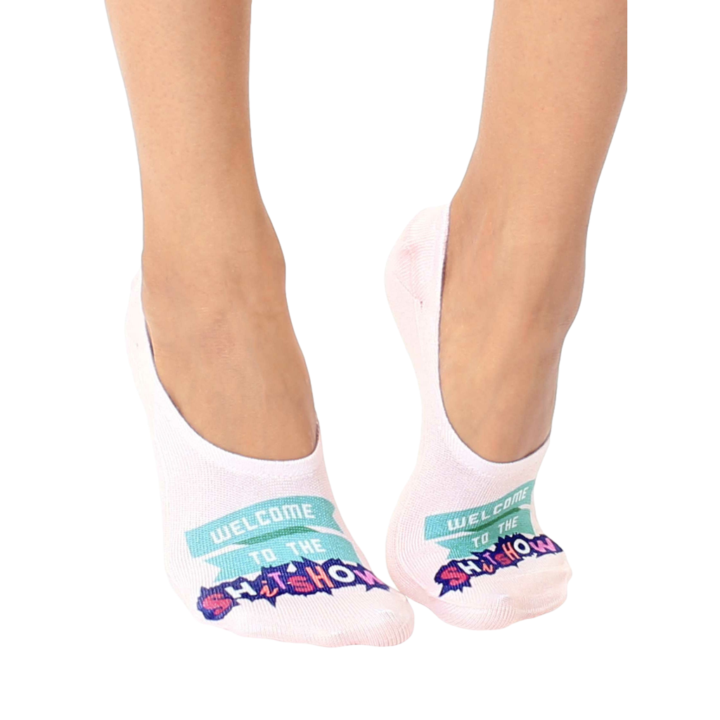 Pair of women's no-show socks in off-white. Feature a teal banner reading 'Welcome to the Shitshow' in a playful font. [lf]