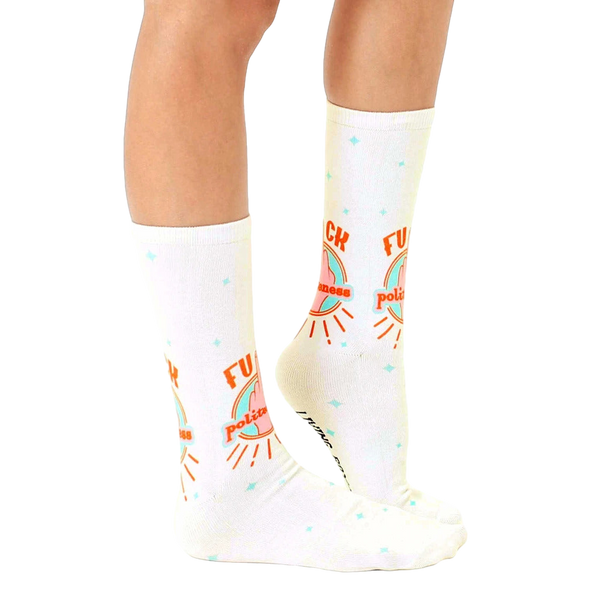 Lifestyle shot of a person modeling the 'F*ck Politeness' socks, showcasing how they look when worn. [lf]