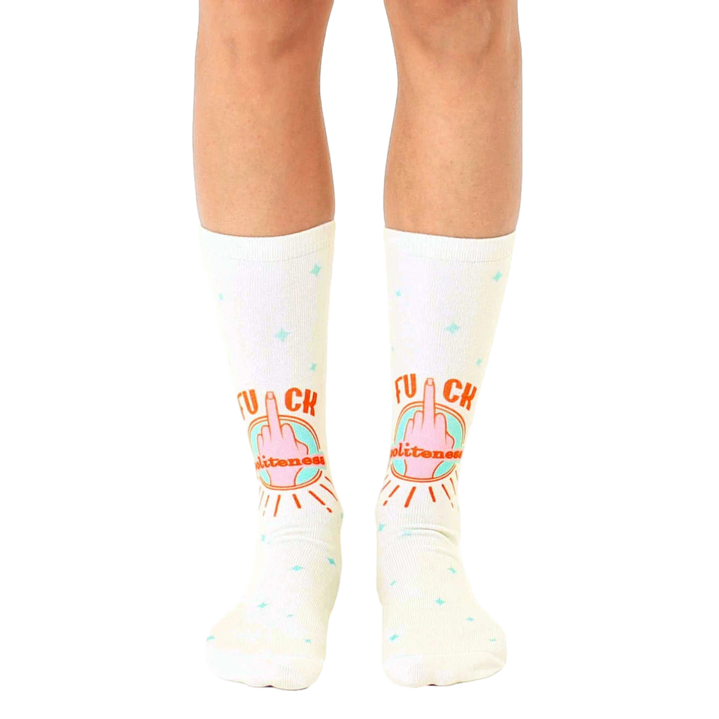 Cream-colored crew socks featuring a repeated design of a middle finger with 'F*ck Politeness' in orange and teal. [lf]