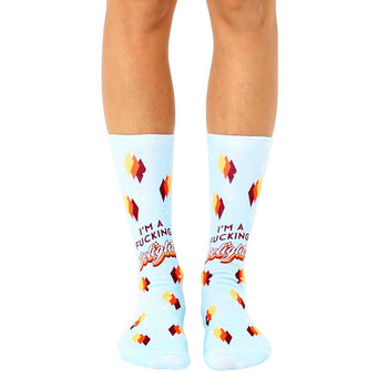 Pair of light blue crew socks with a retro-style design and the phrase "I'm a Fucking Delight" in orange and brown lettering.