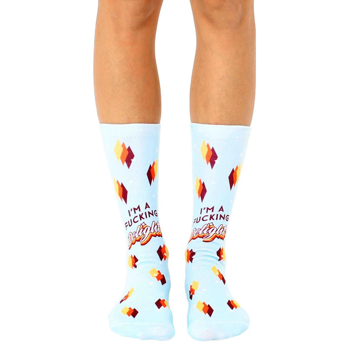 light blue crew socks with a pattern of yellow, orange, and red diamonds with the text 