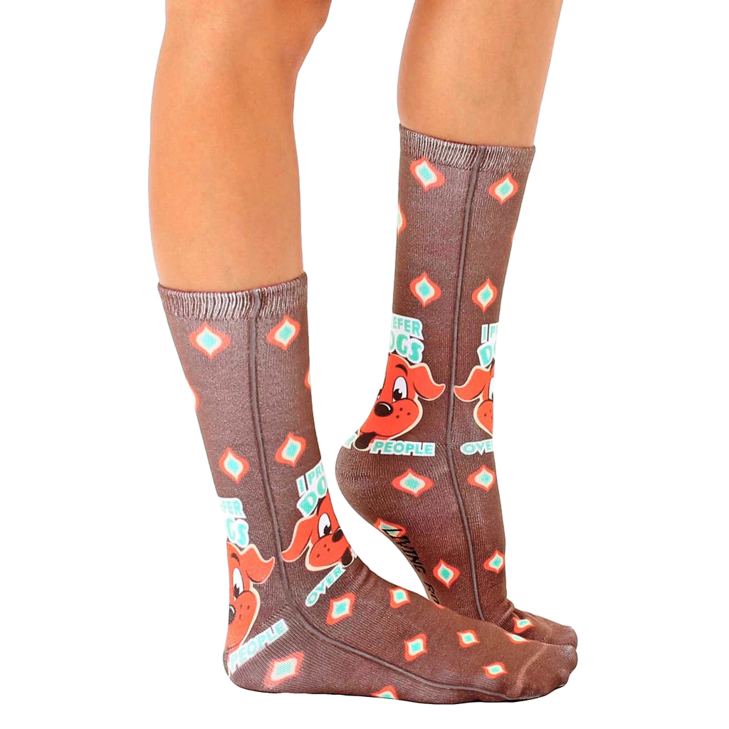 Lifestyle shot showing the 'Dogs Over People' socks on a person's feet. [lf]