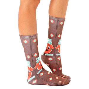 A pair of brown crew socks with a repeating pattern of cartoon dogs in red and white. The socks have the text 