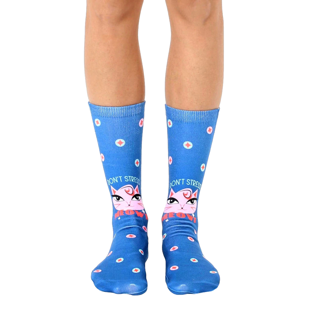 Crew socks in blue with a pink cat face, 'Don't Stress Meowt' text, and teal/white polka dots. [lf]