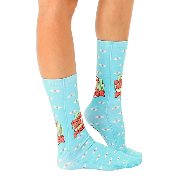 Close-up of 'Don't Be A Prick' socks showcasing the design details and pastel color palette. [lf]